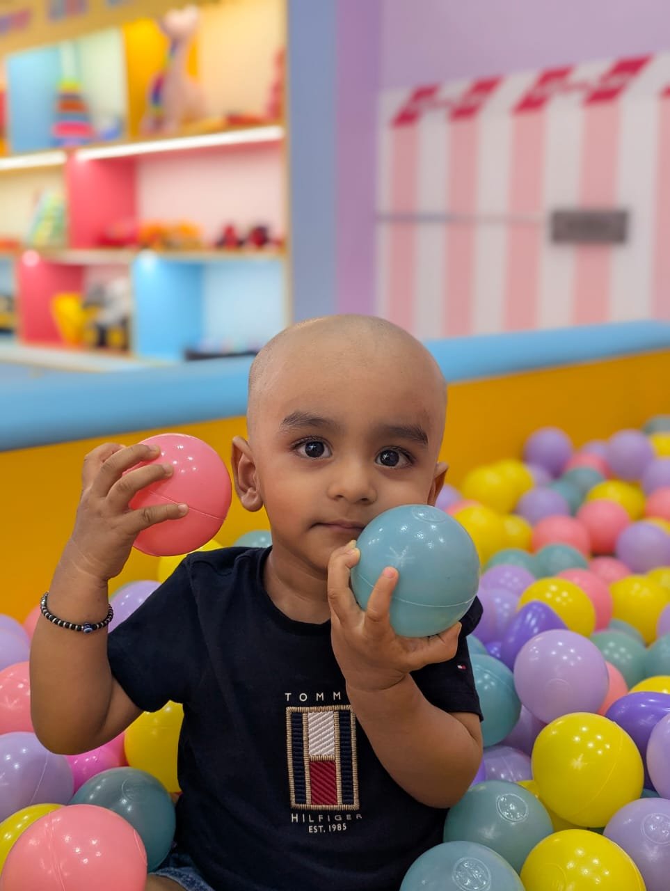 Child playing in a ball pit