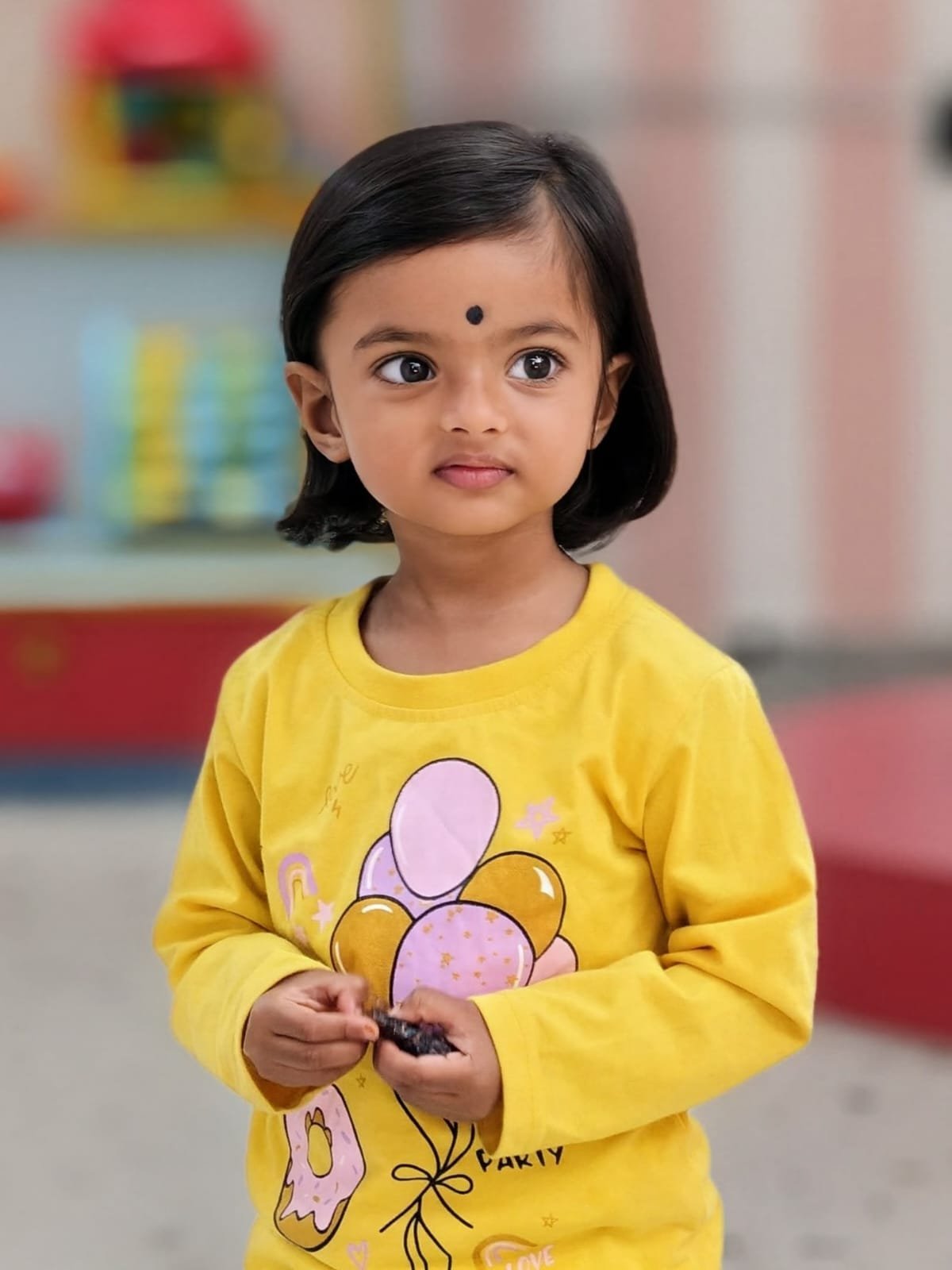 Child with a fresh bob haircut at Lollipop Locs